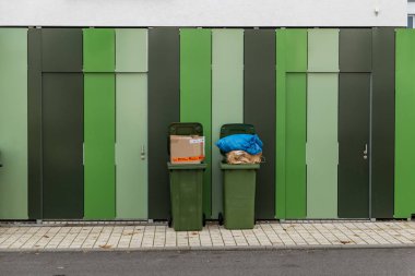 garbage cans with cardboard lettering in german very fragile