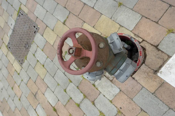 Water hydrant on the road with wheel — 스톡 사진