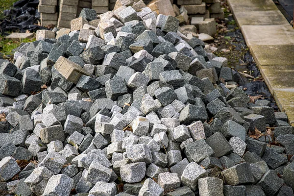 Piles of cobblestones at the roadside for road construction — Stock Photo, Image