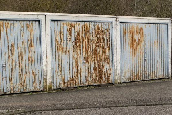 rusty iron garage doors rotten side by side