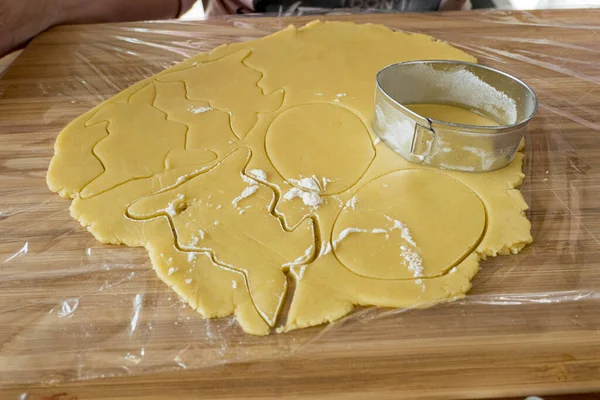 Easter bunny baking tin from sheet with flour and fresh dough