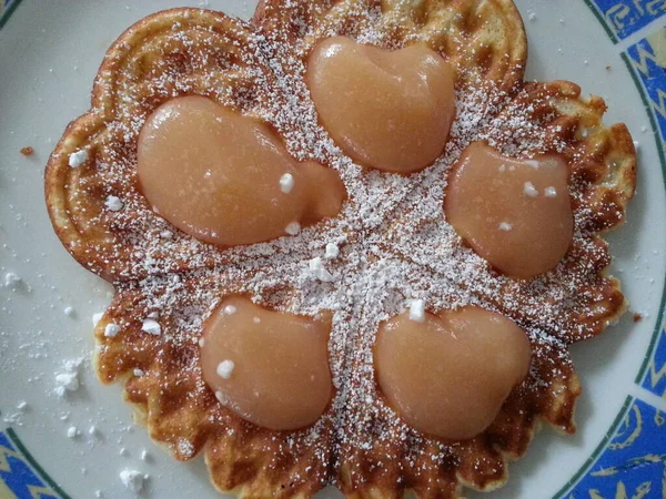 Heart waffles with apple puree and icing sugar