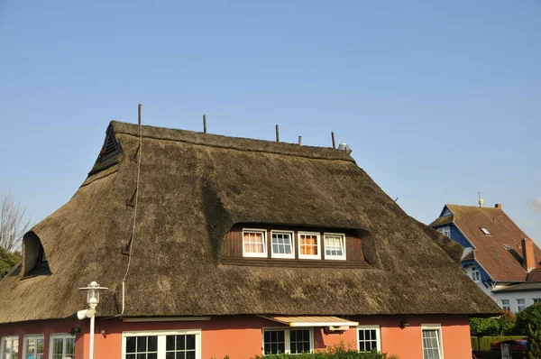 thatched roof in northern germany with blue sky