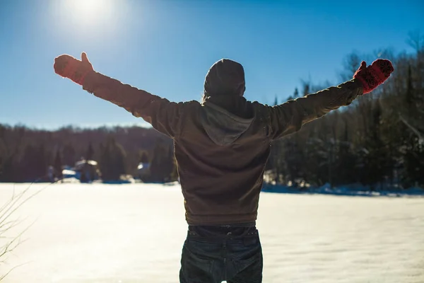 Young man with his arms raised up in the sky — Stock Photo, Image