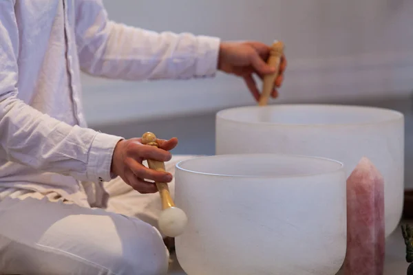 Man playing crystal bowls