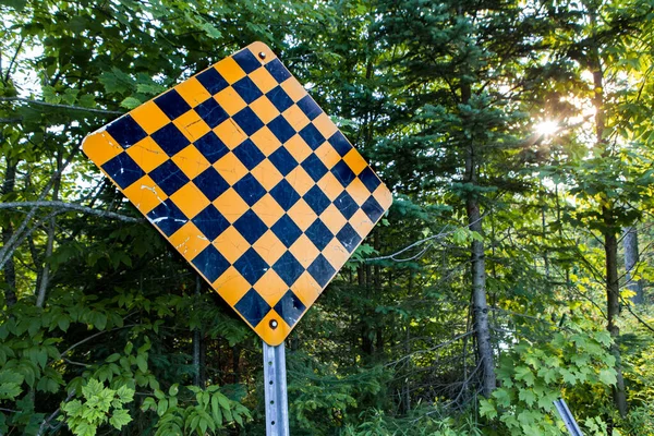 Orange and black warning sign placed in a dead-end Stock Photo