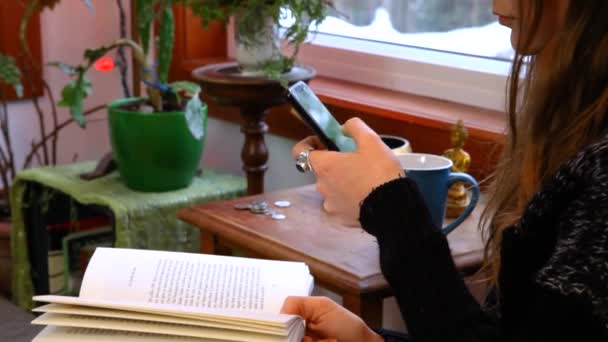 Girl using mobile phone in a living room — Stock Video