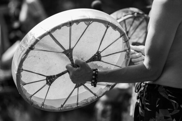 man playing on a sacred drum