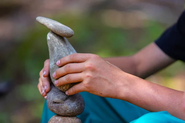 balancing stones in the forest