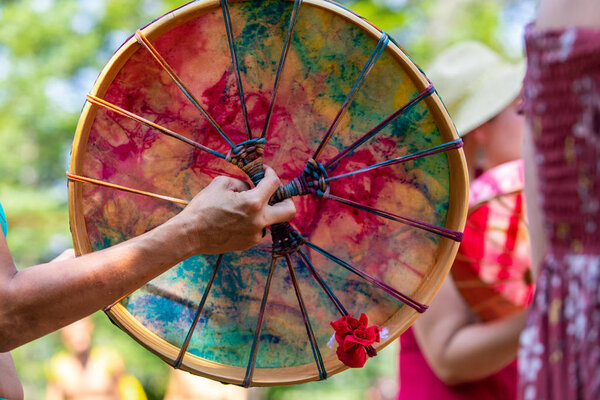 closeup of hand holding a colourful drum