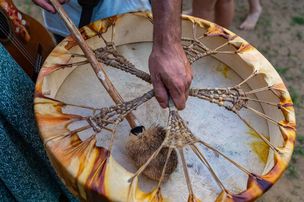 man holding shamanic frame drum