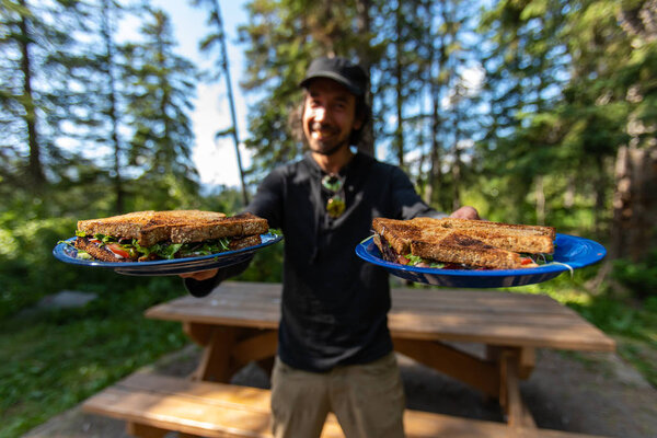 Happy man with food on plates