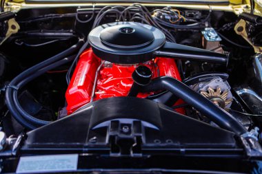 car under hood close up, with red engine
