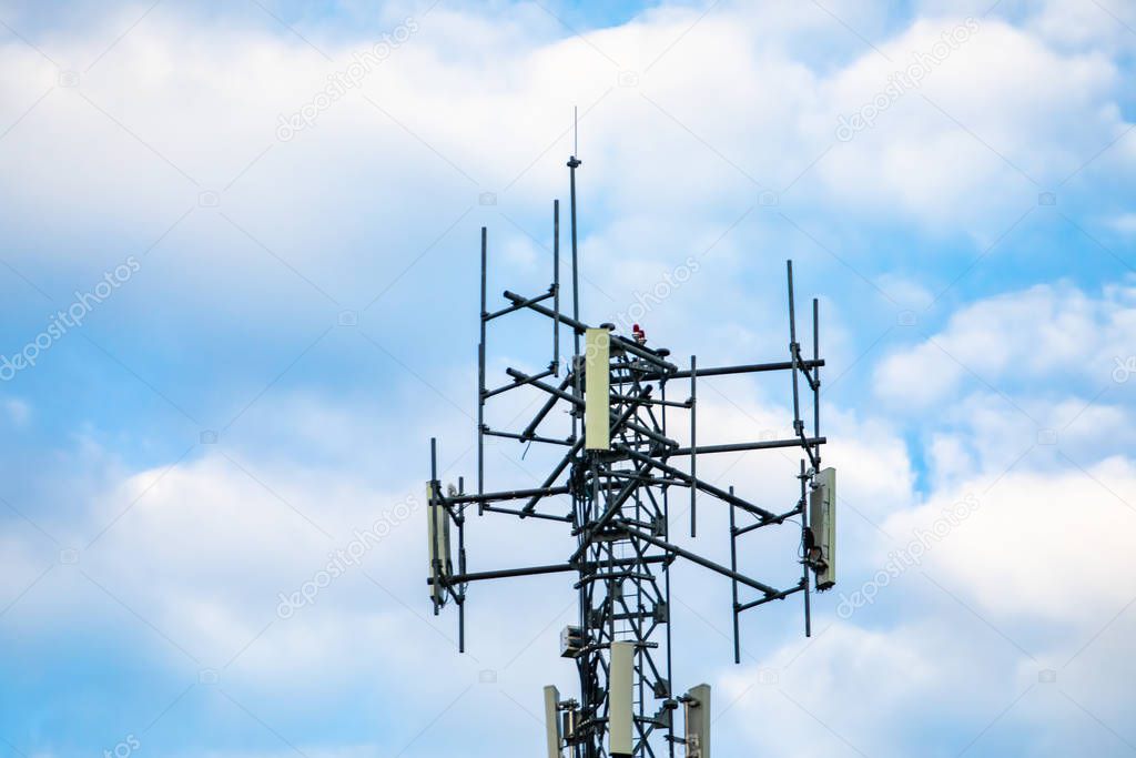 Cellular base station against cloudy sky