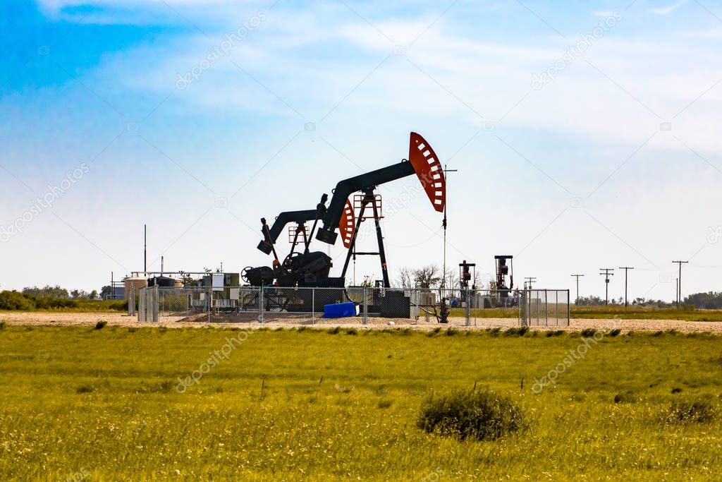 Oil well pumpjack in rural landscape