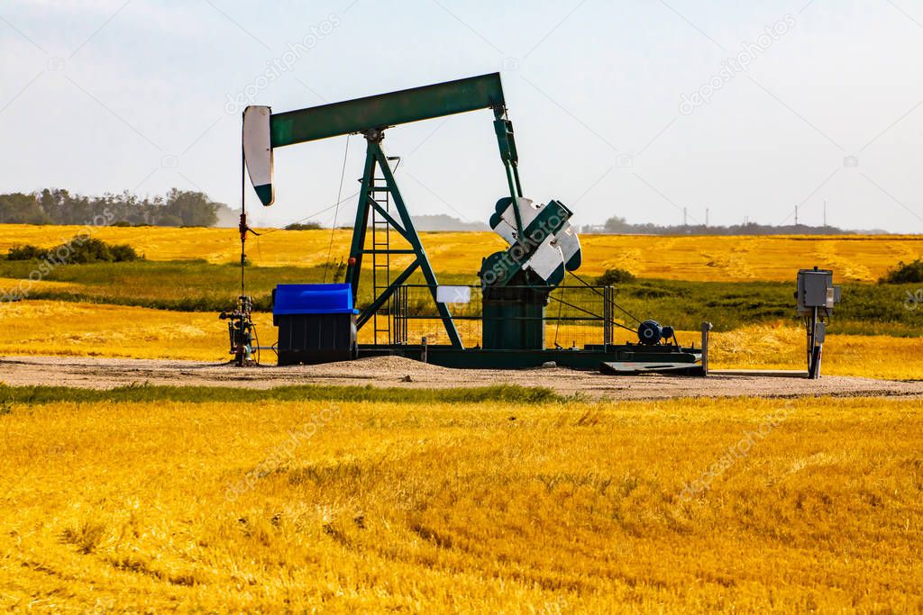 Oil well pumpjack in rural landscape