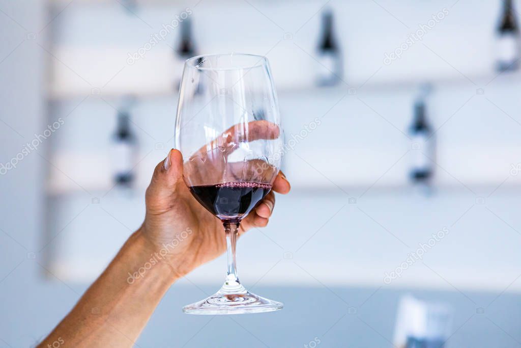a red wine glass, white tasting room