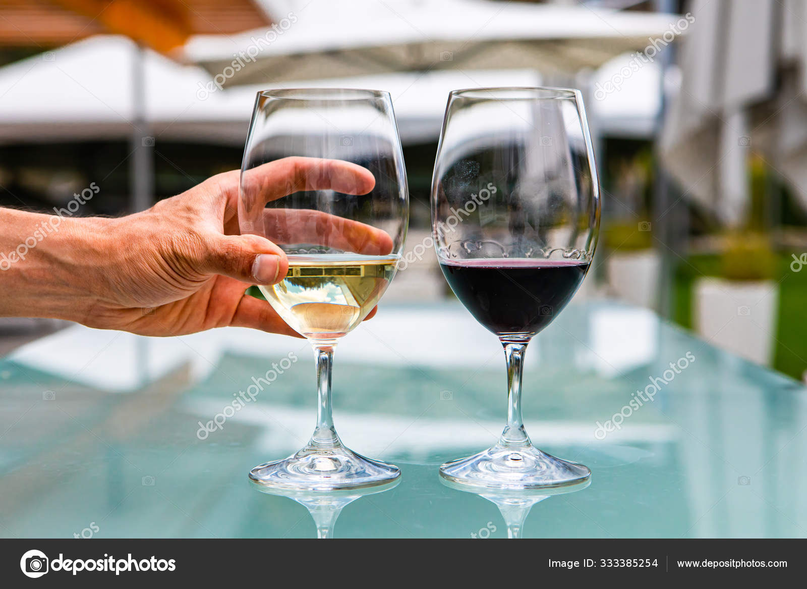 Wine glasses on outdoor glass table — Stock Photo © Valmedia