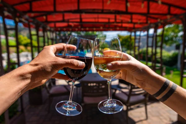 couple hands toasting wine glass outdoor