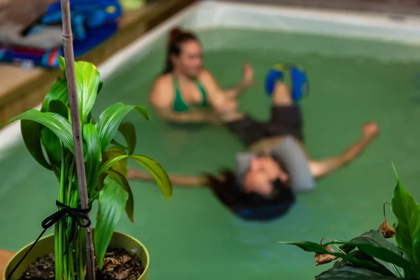 Defocus of man receiving water spa in pool — 스톡 사진