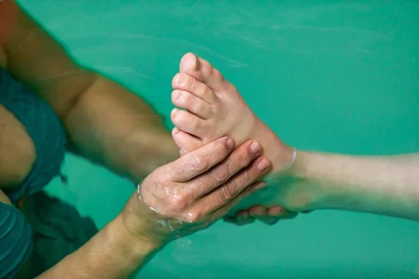 Close-up of therapist hand doing foot massage