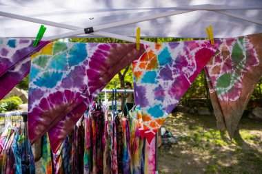 Tie and dye fabrics on a hanging wire