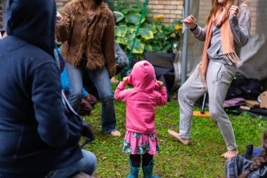 Aile parkta çimlerin üzerinde eğleniyor.