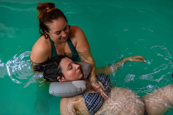 Woman giving breast massage to pregnant lady — Stock Photo, Image