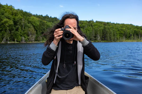 Männlicher Fotograf im Kanu mit DSLR-Kamera — Stockfoto