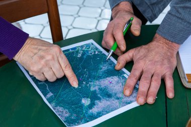 hands pointing on localization on a map