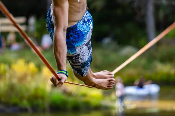 Slack wire artist performs in nature — Stock Fotó
