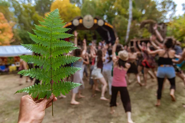 Diverse people dance at earth festival