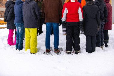 People taking a part in outdoor group yoga class