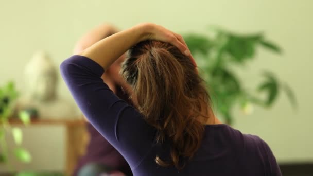 Woman stretching neck muscles by yoga — ストック動画