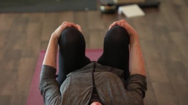 Woman practices multiple knee exercise