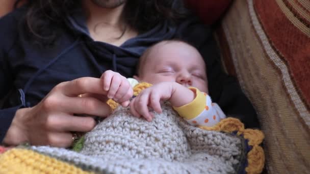 Baby sleeping with father holding finger — Stock Video