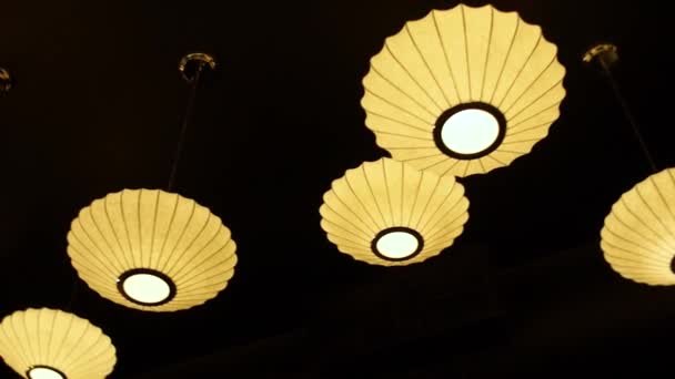 Umbrella ambient lighting in dark restaurant — Stock Video