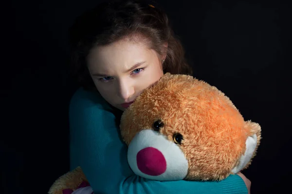 Teenage depression, girl hugging bear — Stock Photo, Image