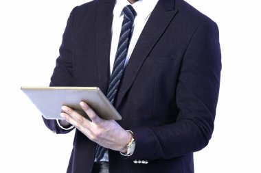 Tablet takım elbiseli bir iş adamının elinde. Çalışırken...