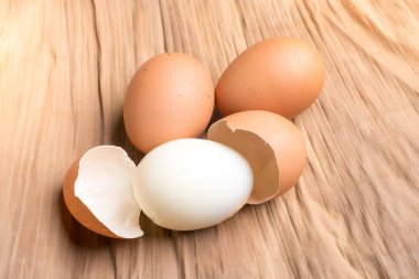 Eggshell and chicken eggs on the ground, brown banana leaves in 