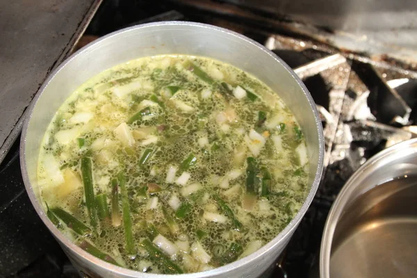 Cooking asparagus soup in a large pot