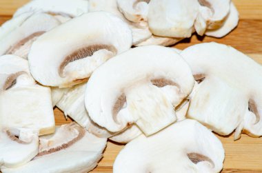 Champignon mushrooms cut into slices close-up, the main source o
