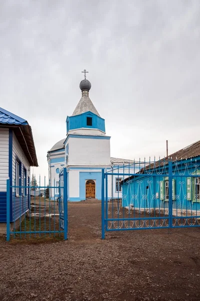 Entrance to the church of the holy apostles Peter and Paul(1824) in the city of Uzhur.The priest's house on the right and the Sunday school on the left.  Krasnoyarsk Territory, Russia.