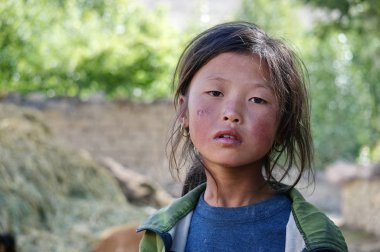 Tsarang, Yukarı Mustang / Nepal - 23 Ağustos 2014: Tibet kökenli düşünceli küçük bir kızın portresi.