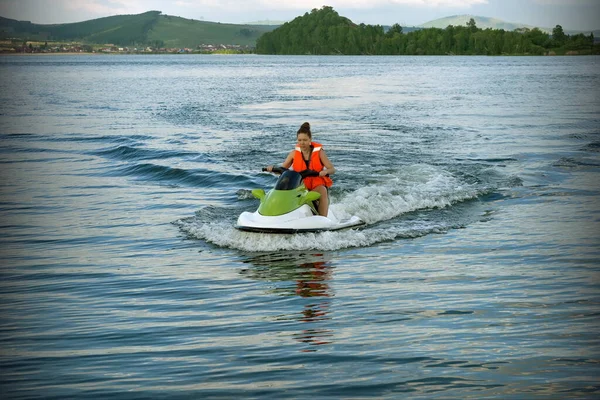 Young Woman Life Jacket Rides Water Bike Lake Backdrop Shore — Stock Photo, Image