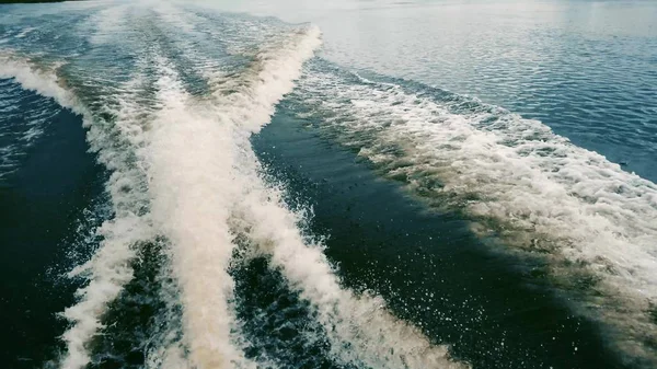 Boat in motion with foam wake behind the stern of fast moving motor boat