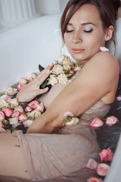 Žena relaxace v kulaté venkovní koupel s tropickými květy, organická péče o pleť, luxusní lázeňský hotel, lifestyle fotografie. — Stock fotografie