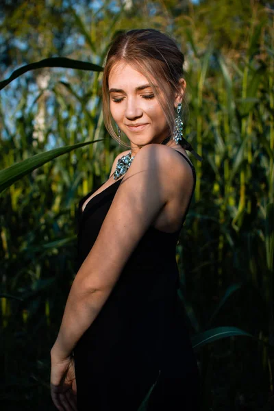 Close Young Woman Black Dress Necklace Earrings Green Leaves Corn — Stock Photo, Image