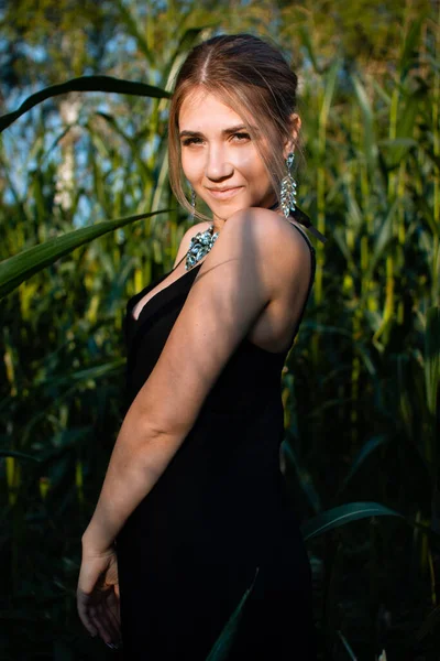 Close Young Woman Black Dress Necklace Earrings Green Leaves Corn — Stock Photo, Image