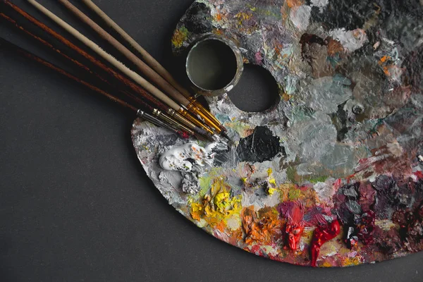 Hobbies, work, art and life in different colors on a palette with a brush. — Stock Photo, Image